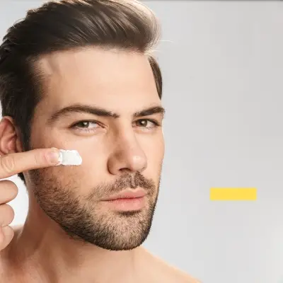 A handsome man is masking his face with sunscreen.